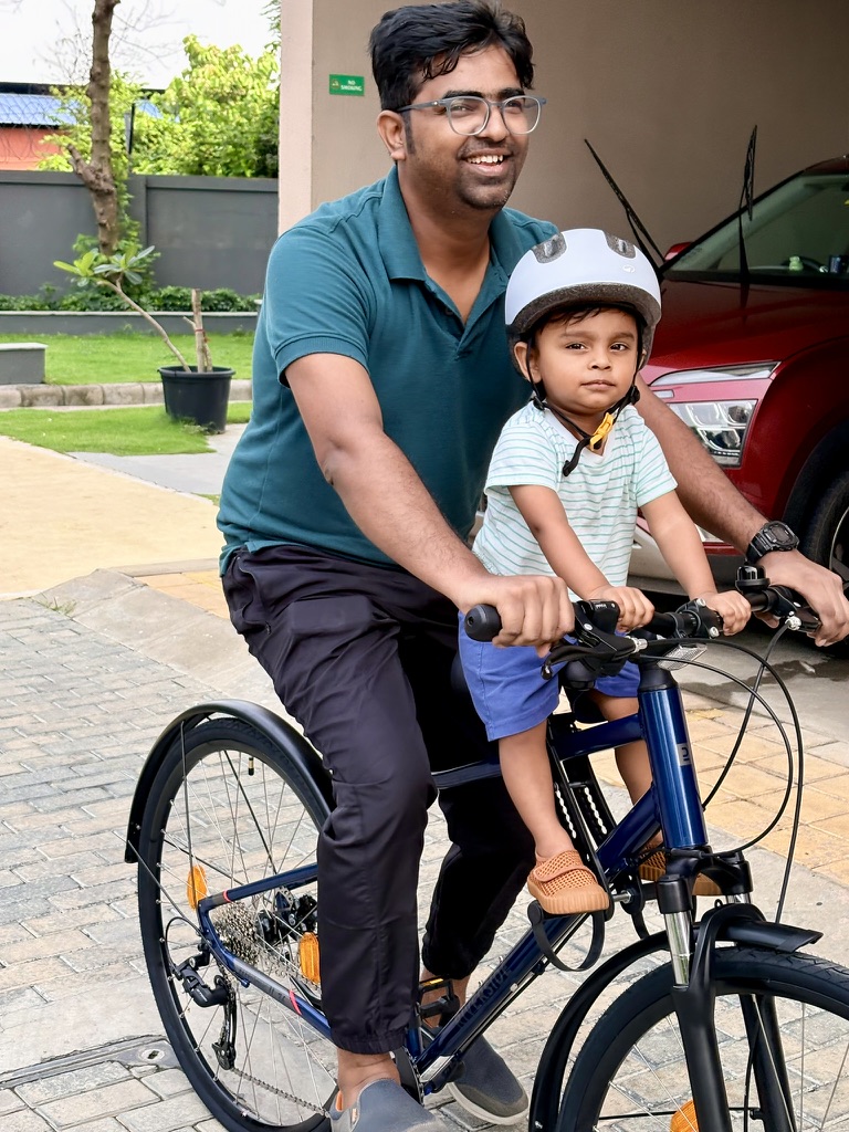 Satyartha riding a bicycle with family